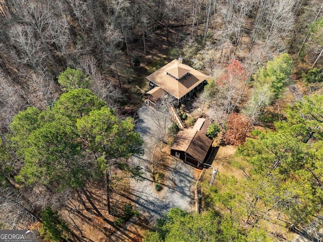 birds eye view of property with a view of trees