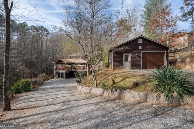 chalet / cabin featuring driveway and a wooden deck