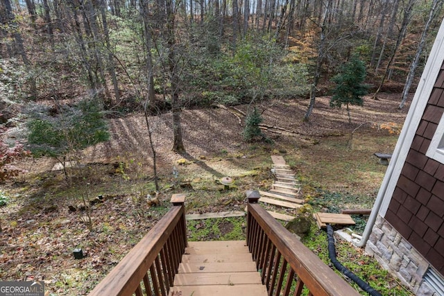 exterior space featuring stairs and a forest view