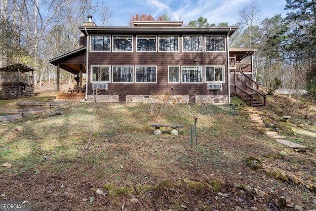 rear view of property with crawl space, a chimney, stairway, and cooling unit