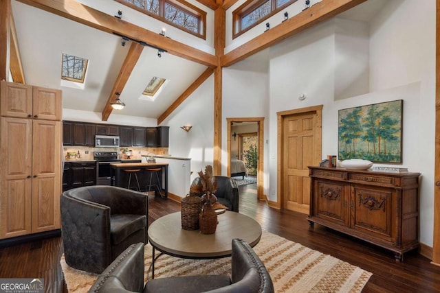 living area featuring high vaulted ceiling, dark wood-type flooring, a skylight, baseboards, and beamed ceiling