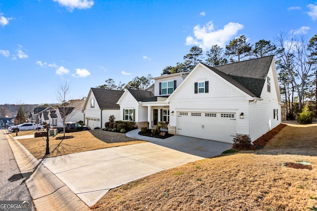 view of front facade with a shingled roof, a residential view, driveway, and an attached garage