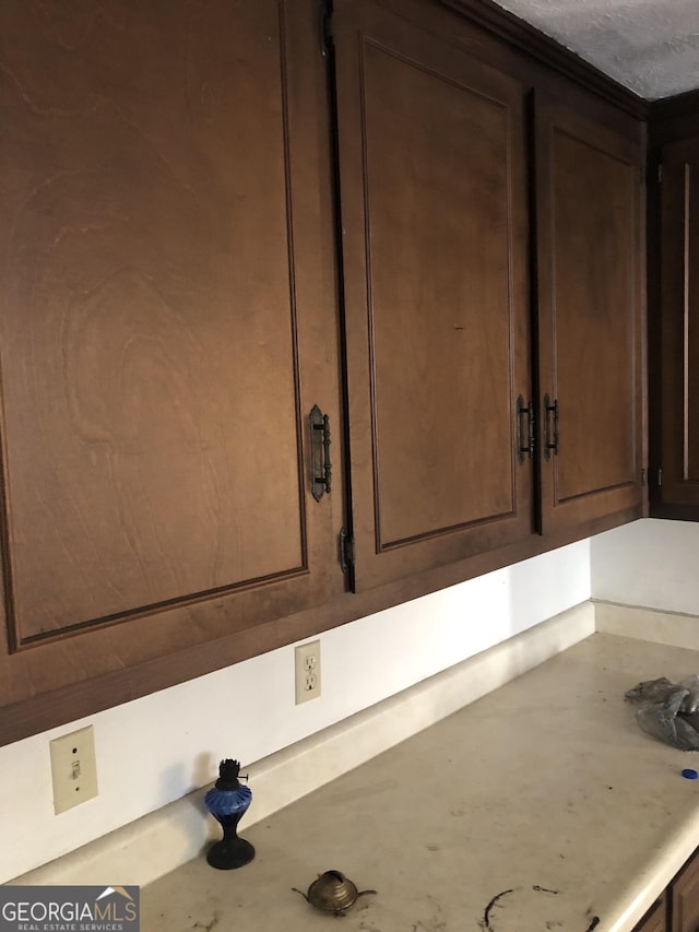 room details with light countertops and dark brown cabinets