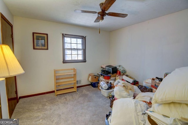 interior space featuring ceiling fan, baseboards, and light colored carpet