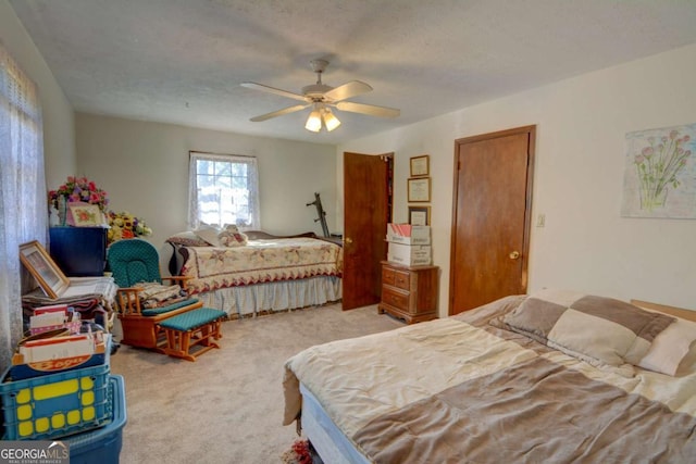 bedroom with light carpet, ceiling fan, and a textured ceiling