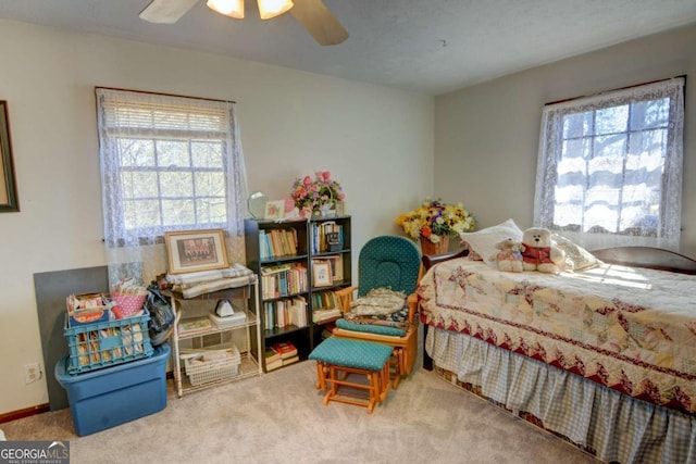 bedroom with baseboards, multiple windows, ceiling fan, and carpet flooring