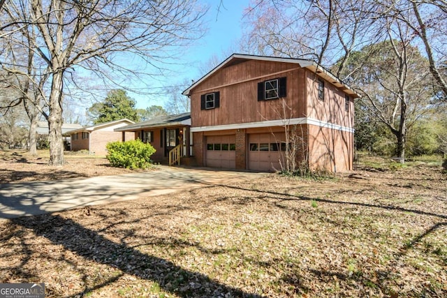 view of front of house with a garage, brick siding, and driveway