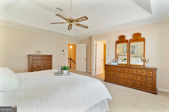 bedroom with visible vents, baseboards, ceiling fan, carpet, and a tray ceiling