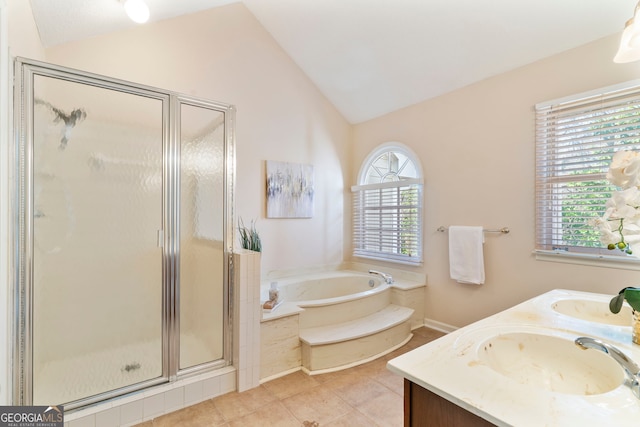 bathroom featuring a stall shower, lofted ceiling, a garden tub, and a sink