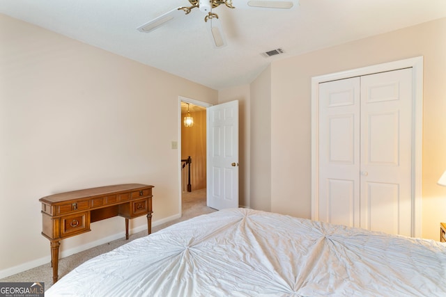 bedroom featuring a closet, carpet flooring, visible vents, and baseboards