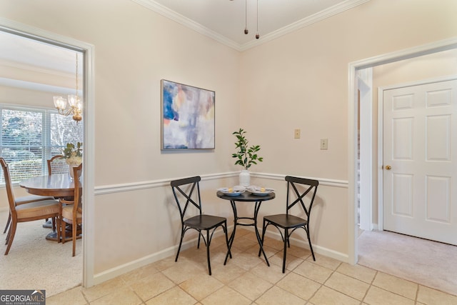 dining space featuring carpet floors, tile patterned flooring, baseboards, and crown molding