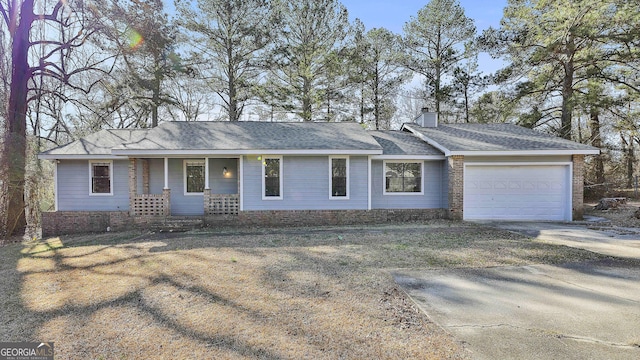 ranch-style home featuring a garage, driveway, and a chimney