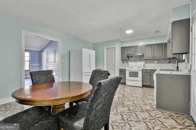 dining space with baseboards, visible vents, and light floors