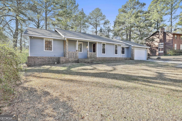 single story home with a garage, covered porch, driveway, and a front lawn