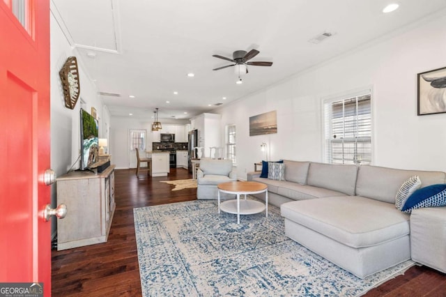 living area with dark wood-style flooring, recessed lighting, visible vents, attic access, and a ceiling fan