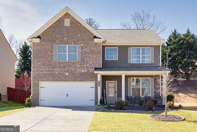 traditional-style home with a garage, concrete driveway, a front lawn, and brick siding