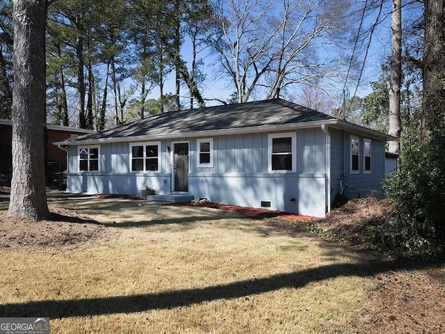 ranch-style house with board and batten siding, brick siding, crawl space, and a front lawn