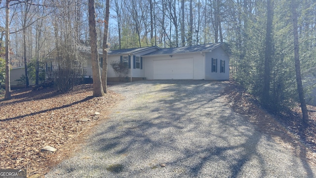 view of side of property with driveway and an attached garage