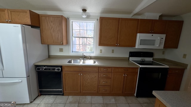 kitchen featuring brown cabinetry, light countertops, a sink, and black appliances