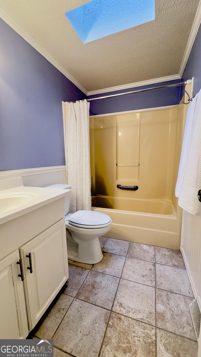 bathroom with a textured ceiling, toilet, a skylight, shower / bath combination with curtain, and crown molding