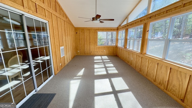 unfurnished sunroom with lofted ceiling and a ceiling fan