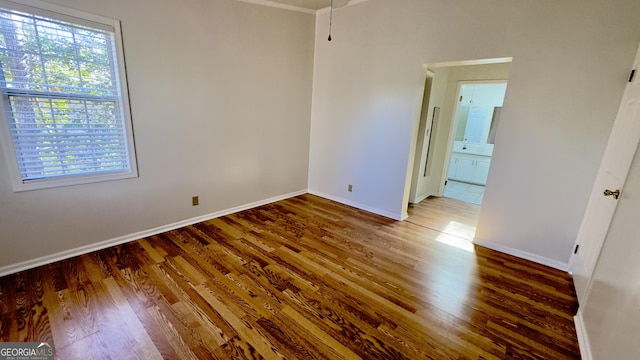 unfurnished bedroom featuring dark wood-style floors and baseboards