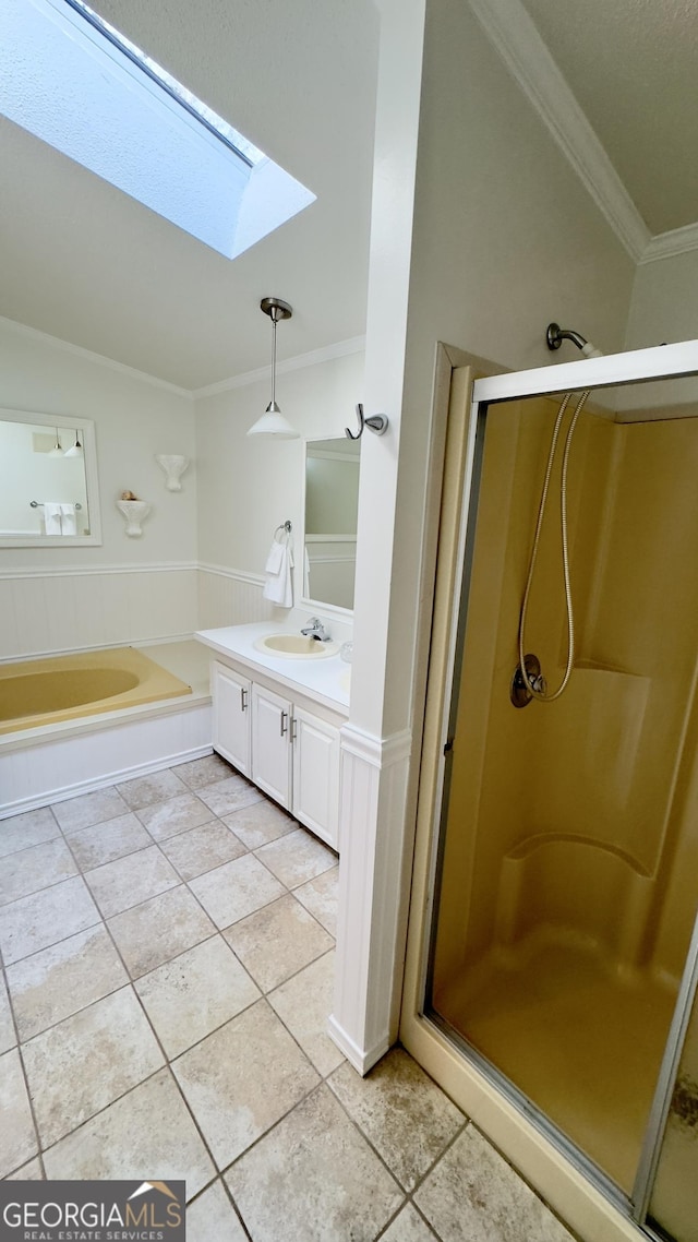 full bathroom with a stall shower, tile patterned flooring, crown molding, and vanity