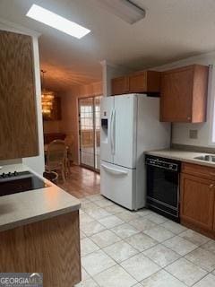 kitchen with black dishwasher, light countertops, and brown cabinets