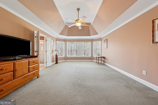 living room with baseboards, a ceiling fan, light colored carpet, a tray ceiling, and crown molding