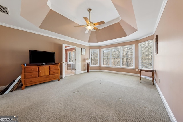 unfurnished living room with light carpet, a wealth of natural light, a raised ceiling, and visible vents