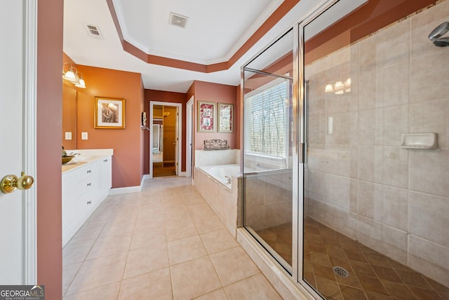 bathroom featuring a tray ceiling, visible vents, a garden tub, and a shower stall