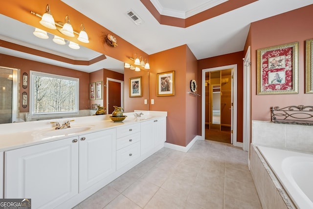 bathroom featuring a sink, visible vents, ornamental molding, a bath, and a raised ceiling