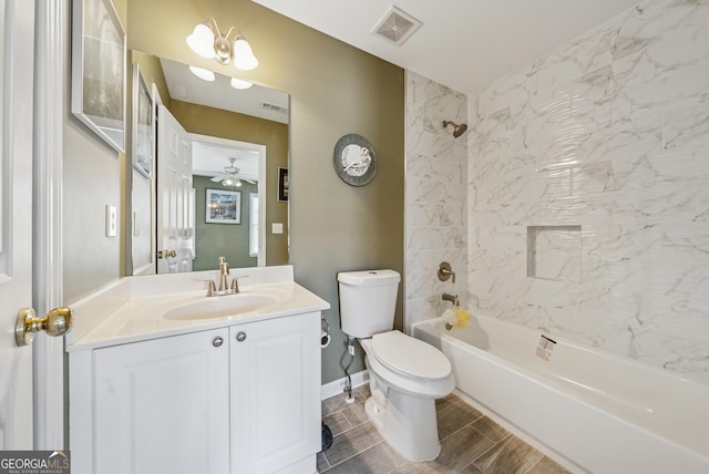 bathroom featuring visible vents, toilet, wood tiled floor, tub / shower combination, and vanity