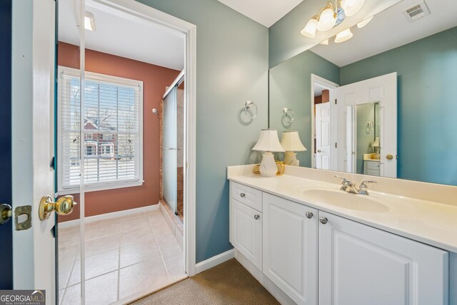 full bathroom featuring vanity, tile patterned flooring, a shower stall, and visible vents