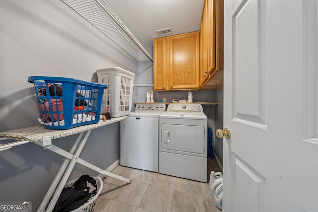 laundry room featuring cabinet space, washing machine and dryer, and visible vents