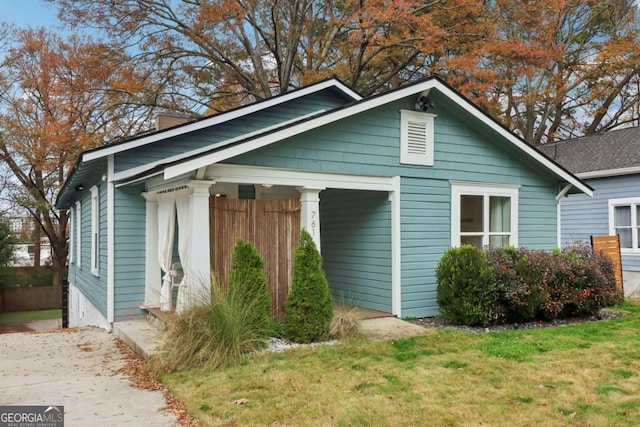 view of side of home with a lawn