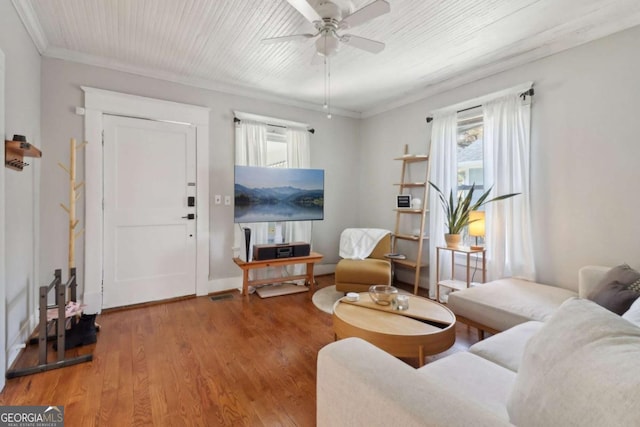 living room with crown molding, a ceiling fan, wood finished floors, wooden ceiling, and baseboards