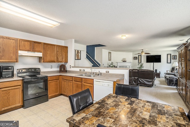 1134 Saint Phillips Ct, Locust Grove, GA 30248 - kitchen with a peninsula, black range with electric stovetop, under cabinet range hood, a sink, and white dishwasher