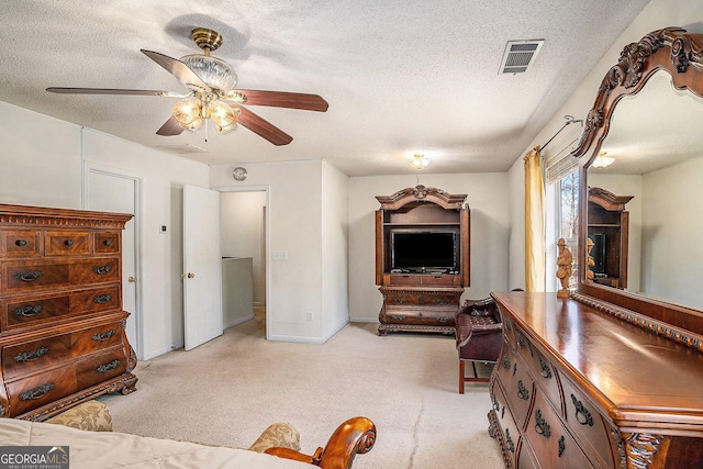 1134 Saint Phillips Ct, Locust Grove, GA 30248 - living area with a textured ceiling, ceiling fan, visible vents, and light carpet