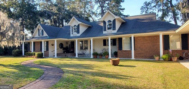 view of front facade featuring a front yard, a porch, and brick siding