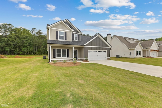 view of front of property featuring board and batten siding, driveway, a front lawn, and central air condition unit