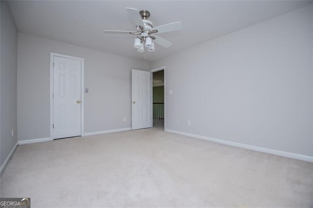unfurnished room featuring light carpet, ceiling fan, and baseboards