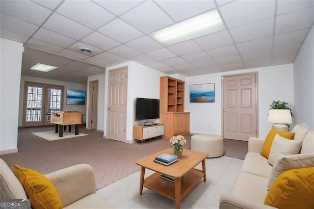 living area with french doors, a paneled ceiling, and visible vents