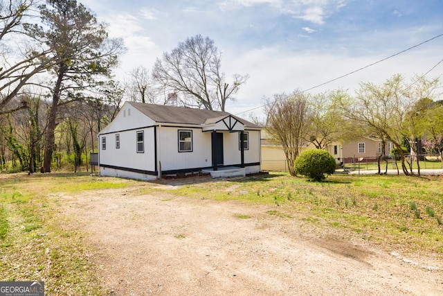 view of front of home featuring fence