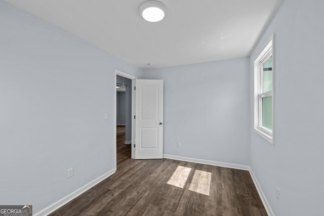 spare room with wood finished floors and baseboards