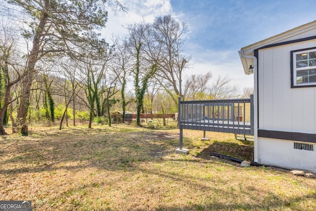 view of yard with a wooden deck