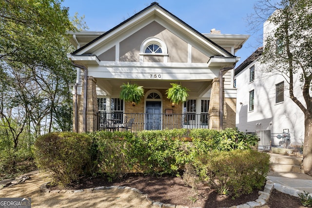 view of front of property featuring covered porch and brick siding