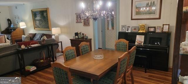 dining area with a notable chandelier and dark wood-style flooring