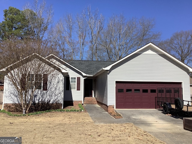 ranch-style house with an attached garage, a shingled roof, and concrete driveway