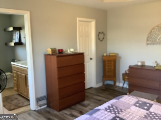 bedroom featuring dark wood-type flooring and baseboards